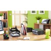 The image shows a modern office space with a green wall, a desk equipped with a computer, stationery holders, stacked documents, a notebook, and decorative plants.