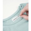 The image shows a hand holding a label that reads 'Nathan Clerc' inside the collar of a light green garment.