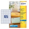 The image depicts a pack of transparent address labels from the brand Avery, with envelopes of different colors in the background. The labels are designed to visually disappear once applied.
