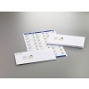 The image shows a stack of white envelopes with a logo and address labels. There is also a sheet with printed labels that can be used for shipping.