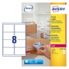 This image shows a package with several labels, as well as a person applying a label to a package.