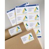 The image shows various address labels with the name and address of individuals, as well as the logo of an architecture firm called 'Abstract Architecture'. The labels are placed on a surface, along with a few envelopes.