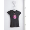 The image shows a grey t-shirt hanging on a wall. The t-shirt features a pink flame design on the front, bordered with small rhinestones. It is hung from a white heart-shaped hook.