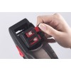 The image shows a hand holding and adjusting a price indicator. The device has a digital and mechanical display with numbers.