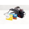 The image shows a price labeling machine and two boxes of medicine, including Aspirin and a product for heartburn.