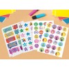 The image features various reward stickers with colorful designs and messages, such as 'Well Done', 'Sports Star', and 'Excellent Work'. They are laid out on a table alongside colorful paper and markers.