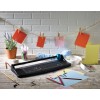 Image of a desk with a paper cutter, colorful papers, clips, and other office supplies. Background with a string from which colorful notes are hanging.