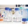 The image shows several bottles of hydrogen peroxide 3% with labels detailing safety information and handling precautions. The bottles are set in a laboratory environment.