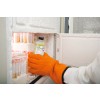 A hand wearing an orange glove is retrieving a bottle from a frozen freezer compartment filled with containers. The interior is frosted, and the contents appear to be cold.